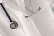A stethoscope draped over a doctor's lab coat